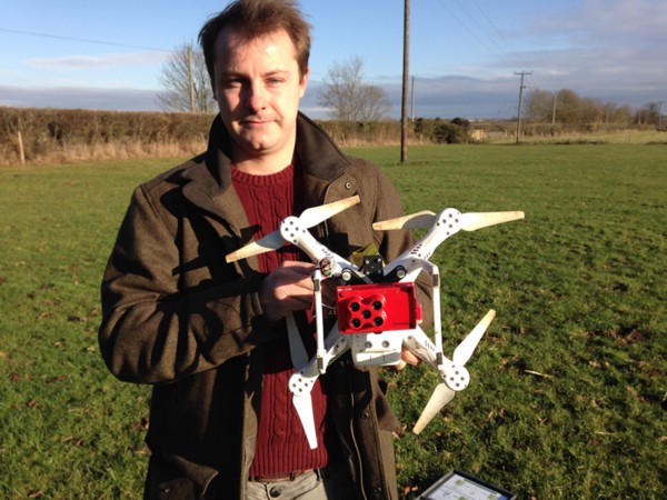 Henry Webber holds the drone and the RedEdge multispectral sensor